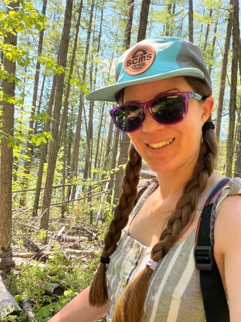 Cassandra Beaumont smiling during a walk in the woods